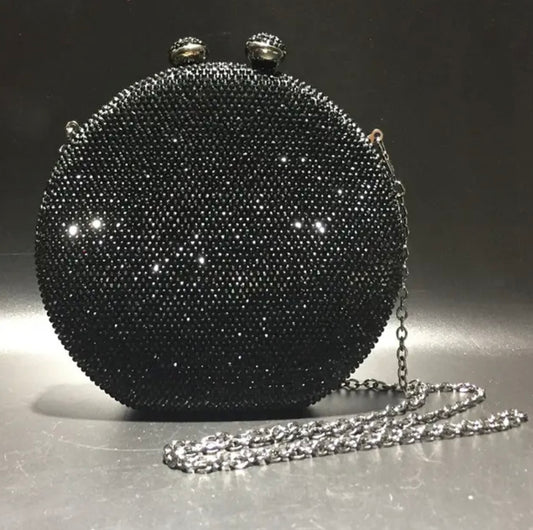 Bolso de mano forma redonda  con pequeños diamantes.